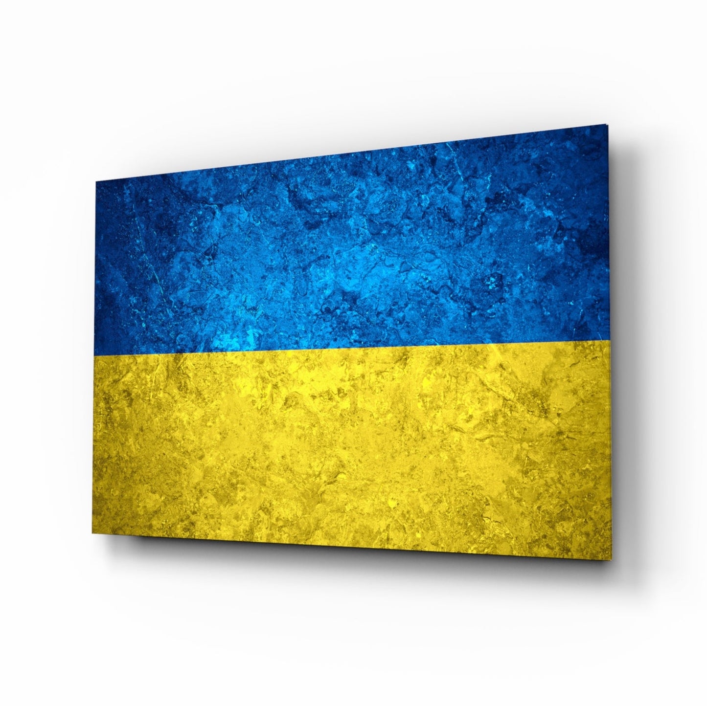 Ukrainian flag glass wall art displayed at an angle, showing blue and yellow textured glass panels with shadow effect.
