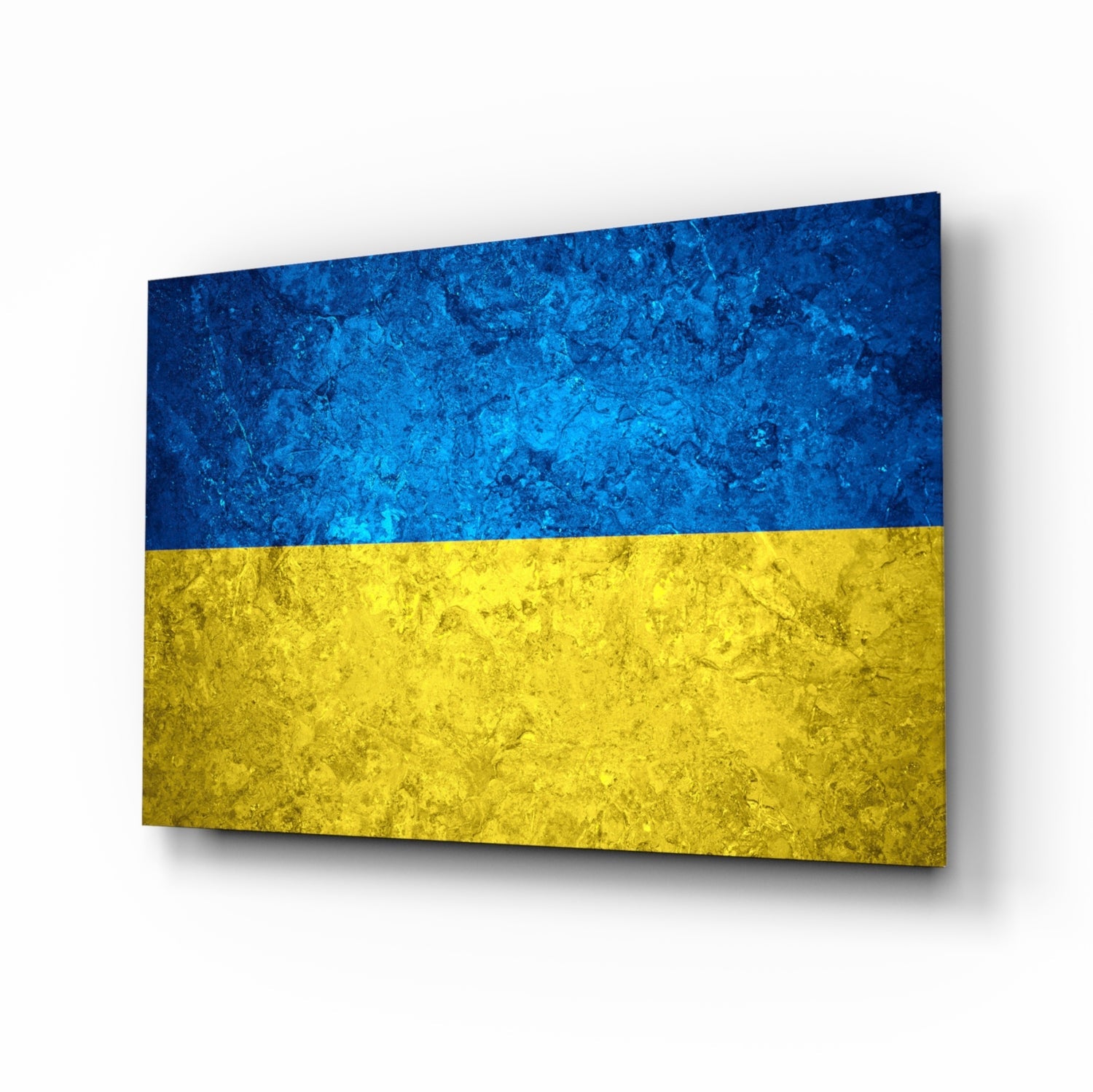 Ukrainian flag glass wall art displayed at an angle, showing blue and yellow textured glass panels with shadow effect.