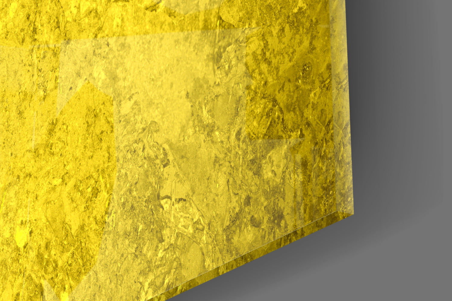 Close-up detail of yellow textured glass surface showing the Ukraine flag's top color against neutral gray background.