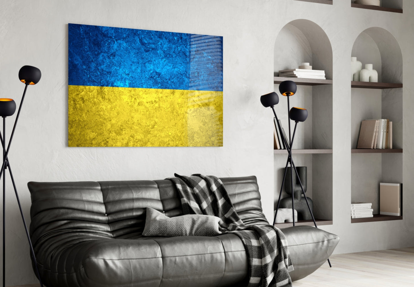 Ukrainian flag glass wall art with blue and yellow horizontal stripes displayed above black leather sofa in modern living room interior.
