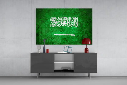 Saudi Arabia flag glass wall art displayed above a dark gray media console in a modern living room setting.