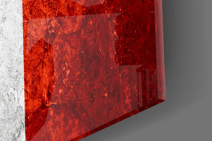 Close-up angled view of red textured glass wall art with white concrete wall edge visible on left side.