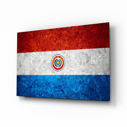 Angled perspective view of a glass wall art panel displaying the red, white, and blue Paraguay flag with central emblem and stone texture finish.