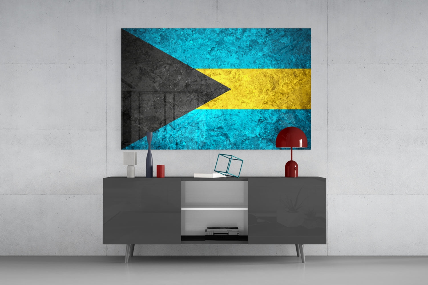 Bahamas flag glass wall art featuring turquoise, black, and yellow chevron design mounted above gray media console with red decorative accessories.