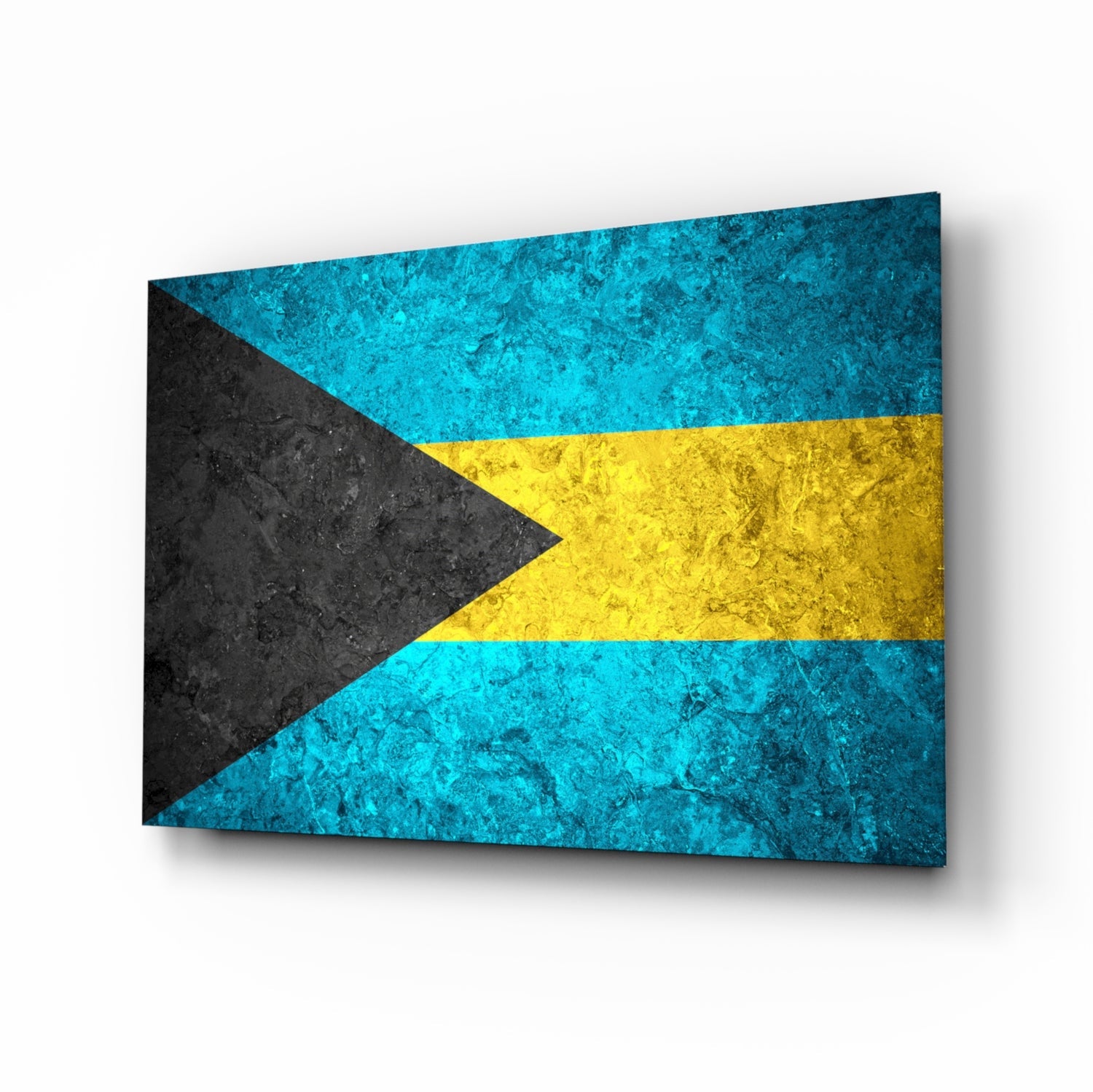 Bahamas flag glass wall art displayed at an angle, showing textured cyan, gold, and black stripes with shadow effect on white background.