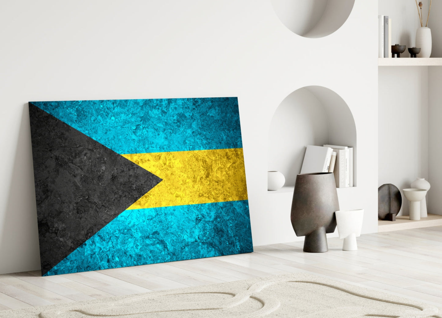 Bahamas flag glass wall art leaning against white wall in minimalist interior with decorative objects.