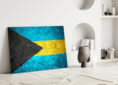 Bahamas flag glass wall art leaning against white wall in minimalist interior with decorative objects.