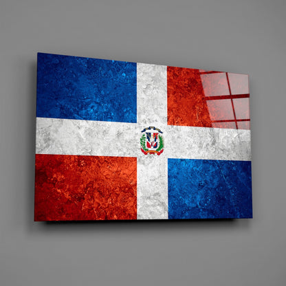 Dominican Republic flag glass wall art displaying blue, white, and red quarters with central coat of arms, angled perspective view.