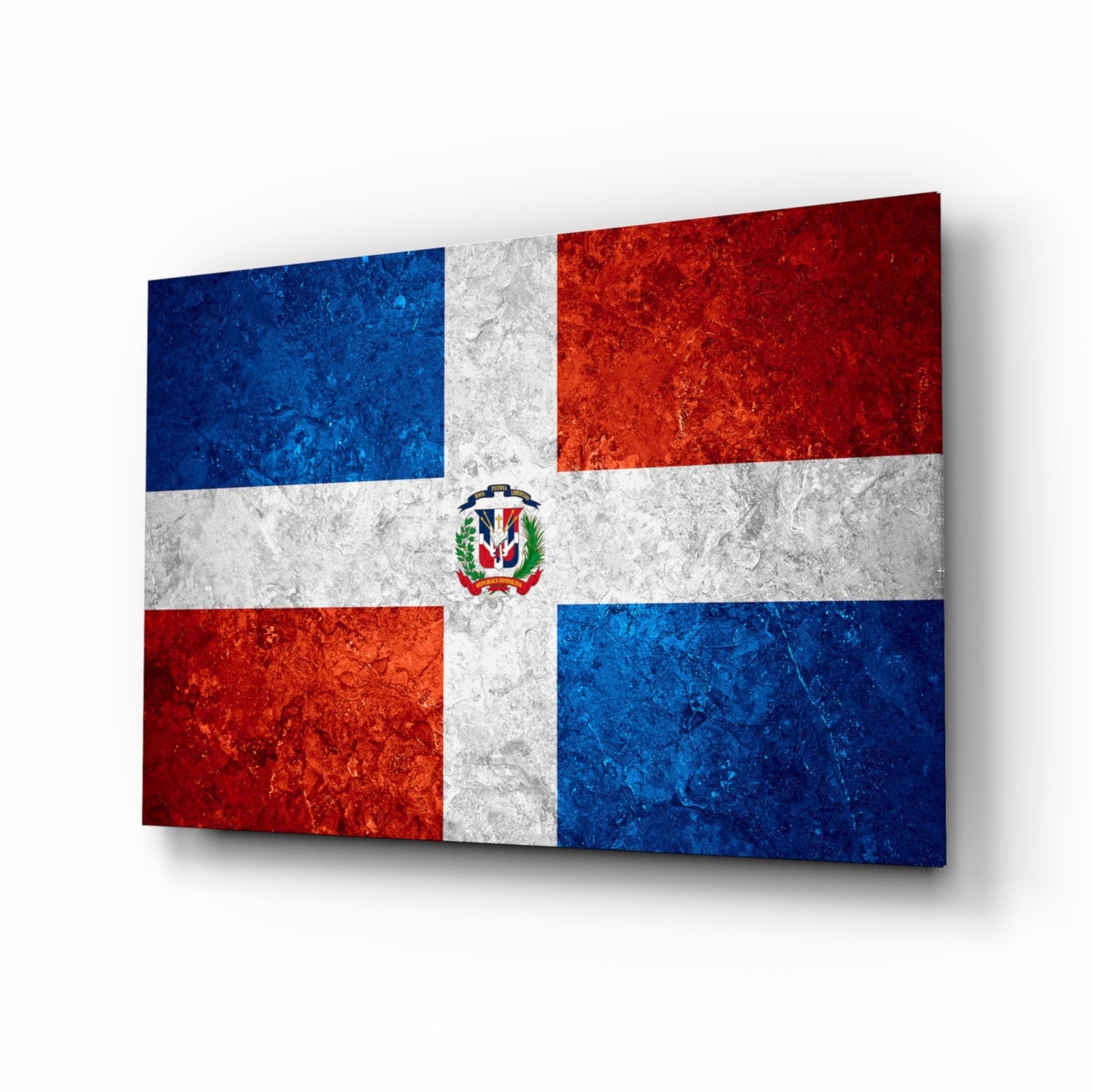 Dominican flag glass wall art displayed at an angle showing blue, white, and red sections with central coat of arms emblem.