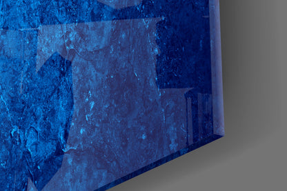 Close-up angled view of blue textured glass wall art with layered translucent panels casting shadows.