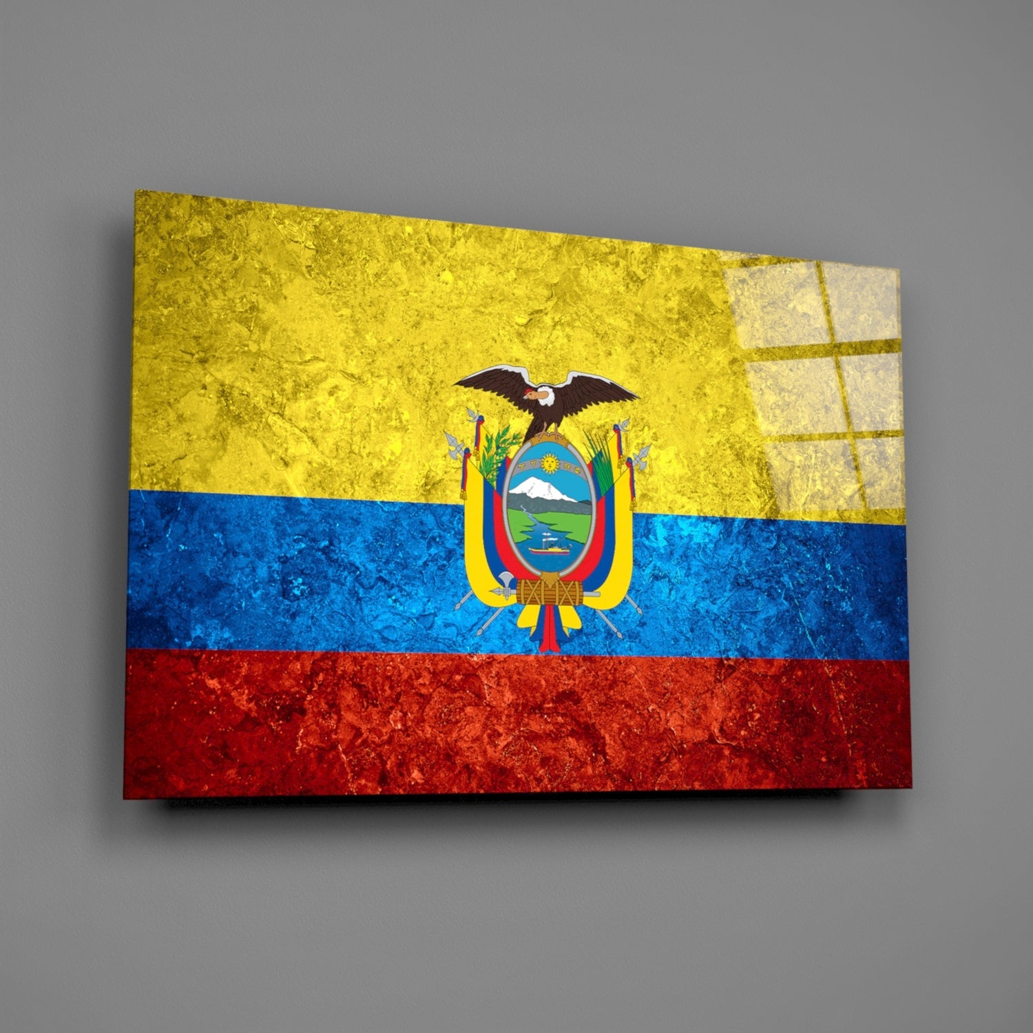 Ecuadorian flag glass wall art displayed at an angle against gray background, showing yellow, blue, and red horizontal stripes with central coat of arms.