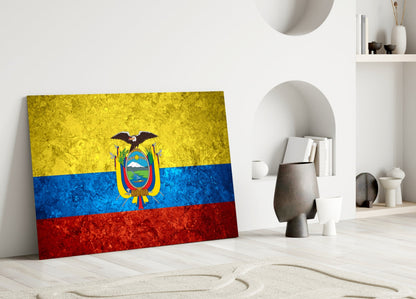 Ecuador flag glass wall art leaning against white wall in minimalist interior space with decorative objects.