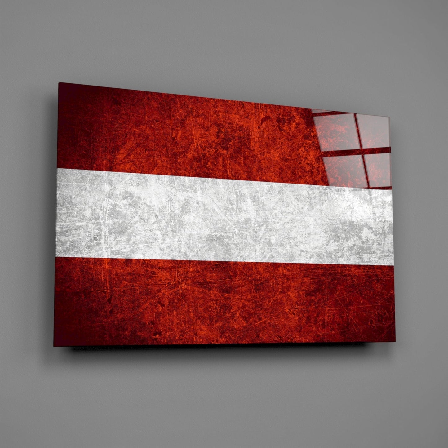 Austrian flag glass wall art mounted at an angle, displaying red-white-red horizontal stripes with textured surface and shadow on gray wall.