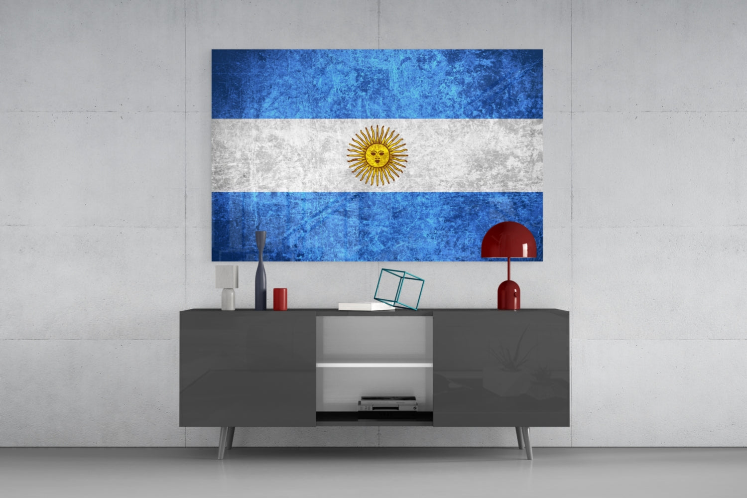 Argentina flag glass wall art hanging above gray media console with decorative objects in modern interior setting.