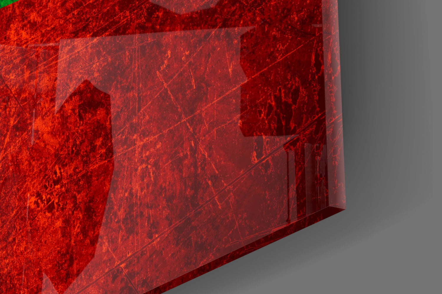 Close-up angle of red textured glass wall art with scratched surface detail and layered translucent panels.