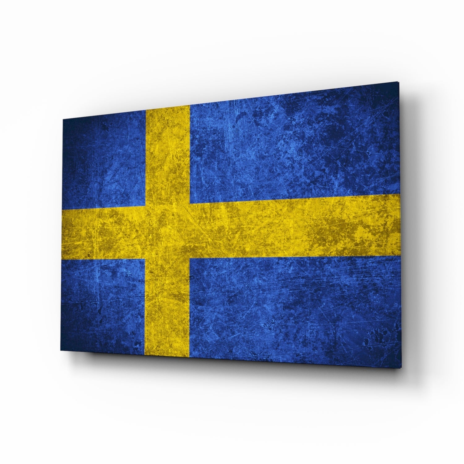 Swedish flag with blue and yellow cross on textured glass panel displayed at angled perspective.