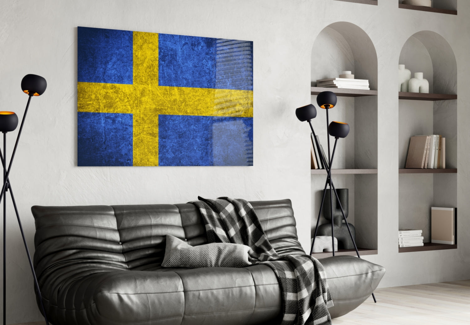 Swedish flag glass wall art hanging above black leather sofa in modern living room interior.