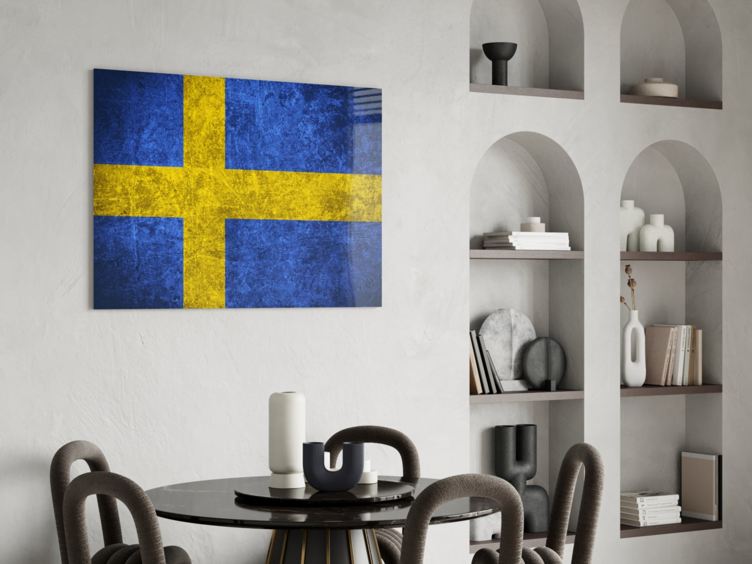 Swedish flag glass wall art with blue and yellow cross displayed above a dining table in a modern interior setting.