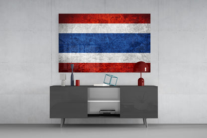 Thai flag glass wall art with red, white, and blue horizontal stripes displayed above gray media console in modern interior.