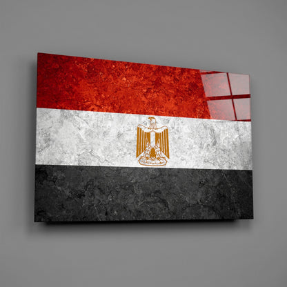 Three-dimensional glass wall art displaying Egypt's flag with red, white, and black horizontal stripes and golden eagle emblem, angled perspective view.