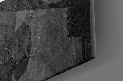 Close-up angled view of textured dark gray glass surface with subtle surface details and reflections.