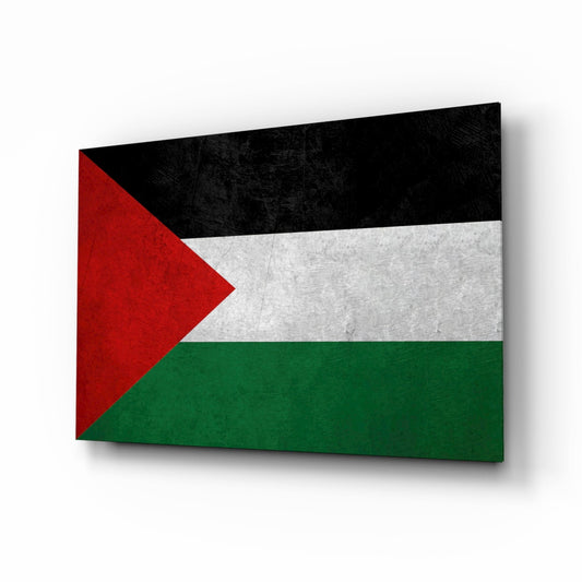 Palestinian flag with red, white, black, and green colors displayed on matte stone textured glass panel at angled perspective.
