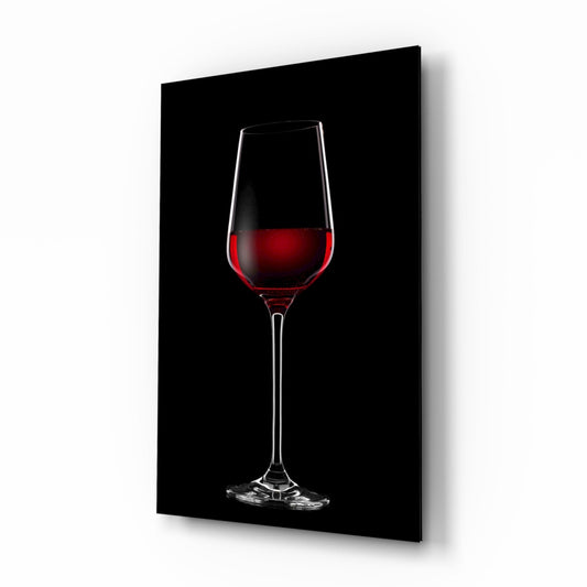 Glass wall art panel displaying a single red wine glass with deep crimson liquid against a black background, shown at a three-quarter angle.