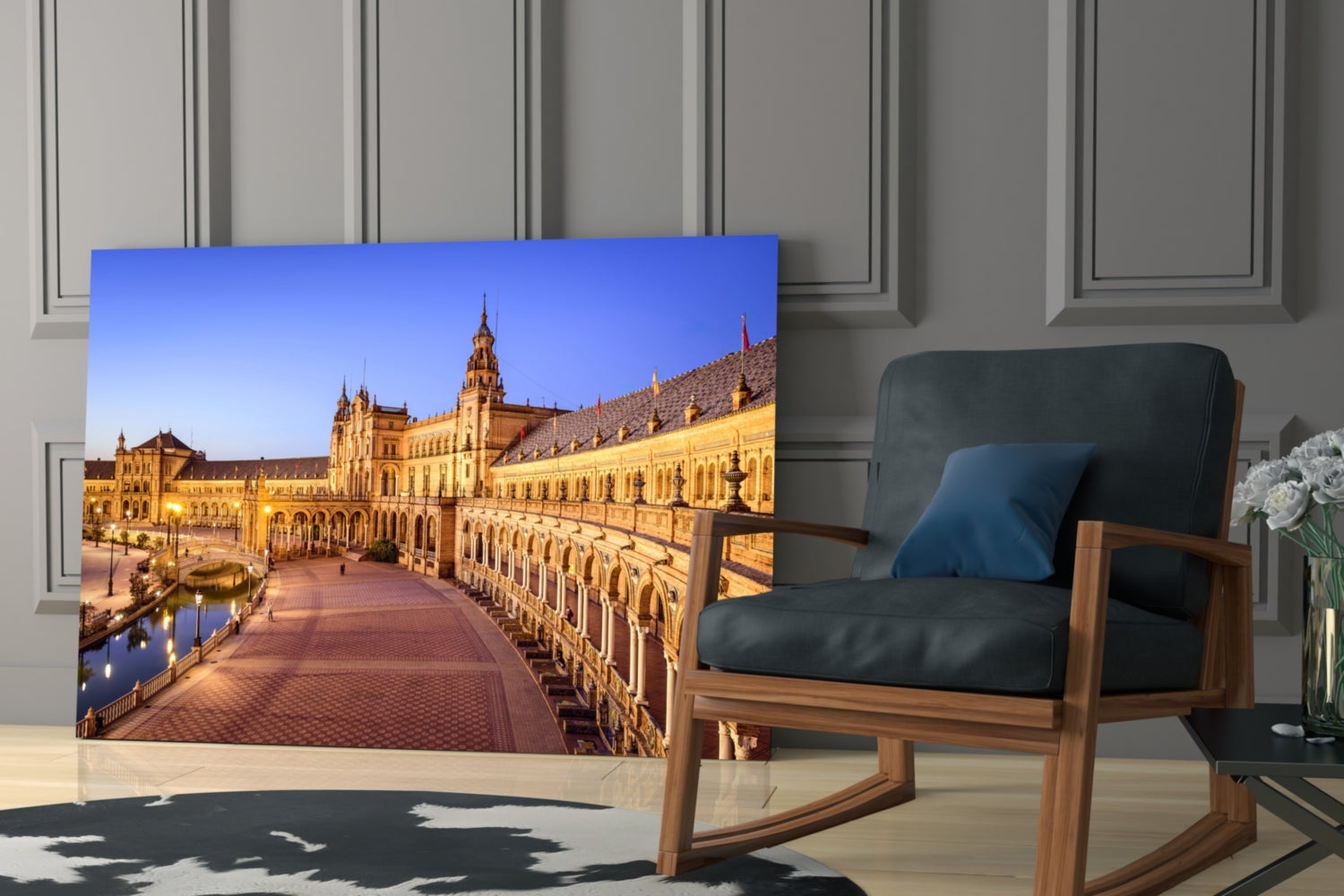 Glass wall art displaying illuminated Plaza de España architecture in Seville with golden buildings and blue sky, displayed in modern living room setting.