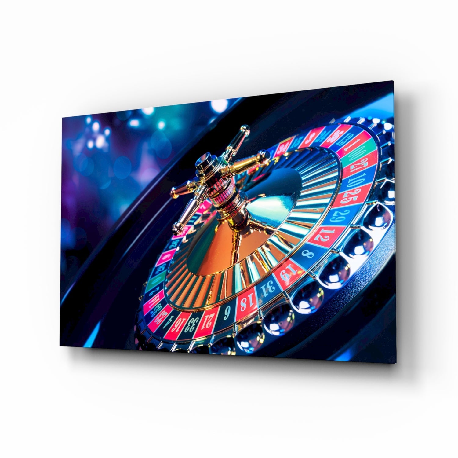 Angled view of glass wall art depicting a gold roulette wheel with red and blue numbered sections against dark blue background with bokeh lighting.