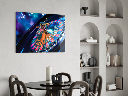 Roulette glass wall art displaying a colorful illuminated casino wheel mounted above a dining table in a modern interior.