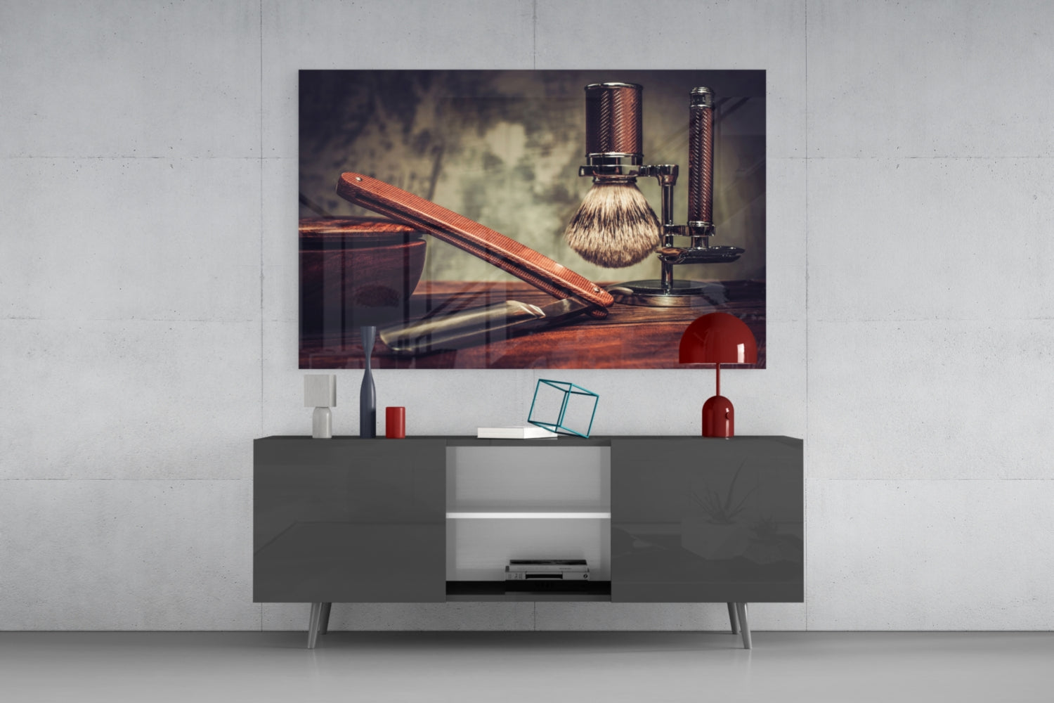 Vintage shave glass wall art displayed above gray media console, showing wooden straight razor, brush, and stand in warm tones.