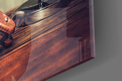 Close-up of vintage shave glass wall art showing rich wood grain texture, metal faucet fixture, and orange fabric detail against neutral background.
