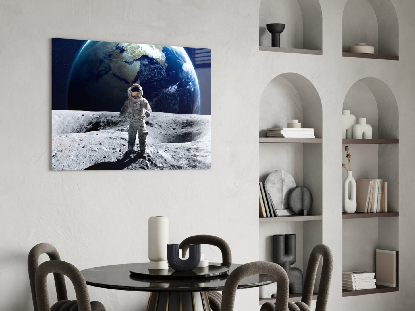 Astronaut in spacesuit standing on lunar surface with Earth rising in background, displayed as horizontal glass wall art above dining table.