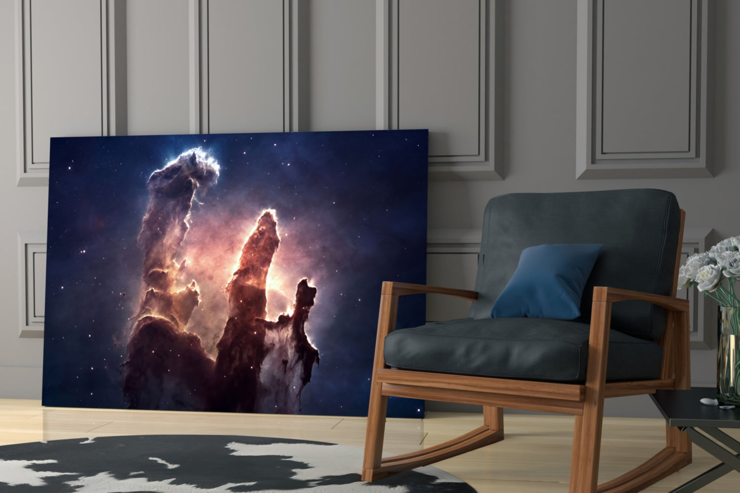 Space Clouds Glass Wall Art displaying a nebula with glowing pillars of dust and stars, displayed in a modern living room next to a wooden chair.