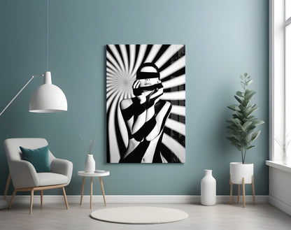 Black and white pop art style glass wall art depicting a figure with a censored face against radiating striped background, displayed in modern room setting.