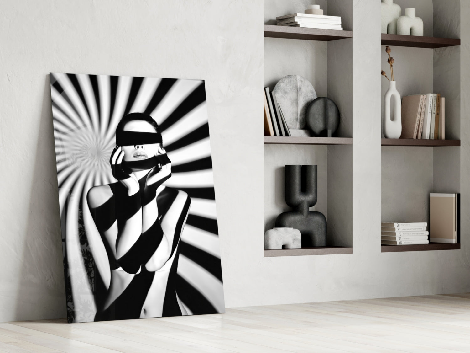 Black and white pop art glass panel leaning against white wall beside built-in shelving with decorative objects and books.