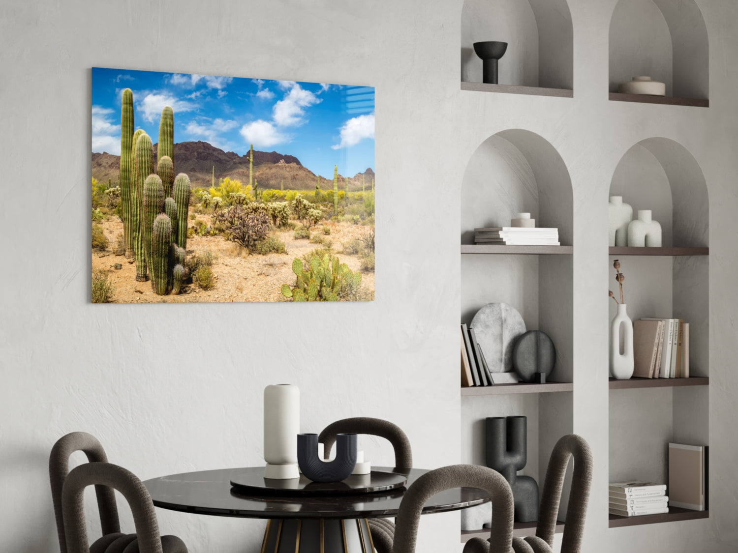 Desert landscape with tall saguaro cactus and mountains displayed as glass wall art above dining table.