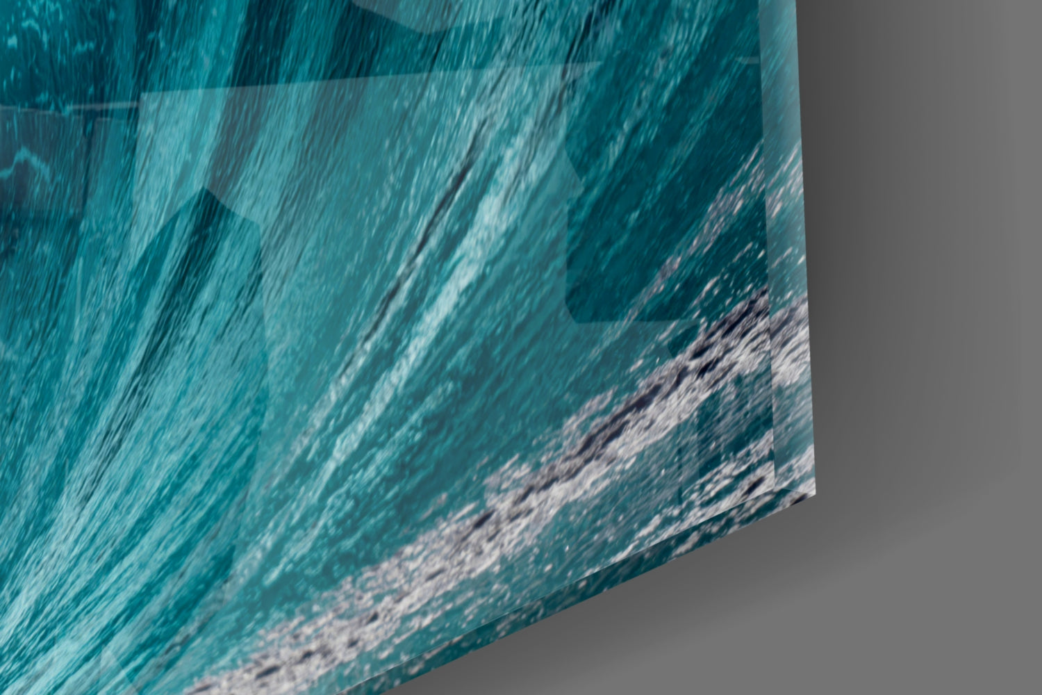 Close-up angled view of textured glass art displaying turquoise ocean waves with white foam detail.
