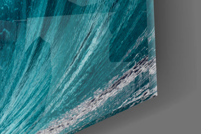 Close-up angled view of textured glass art displaying turquoise ocean waves with white foam detail.