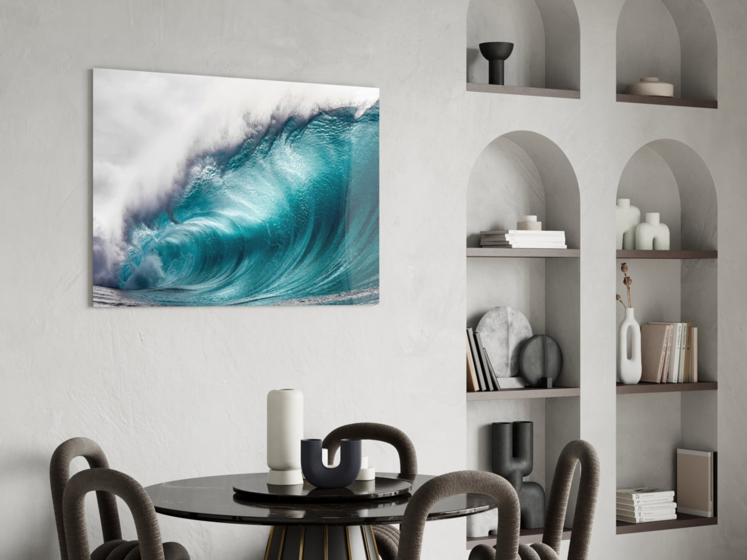 Turquoise ocean wave with white foam displayed as glass wall art above a dining table in a modern interior.