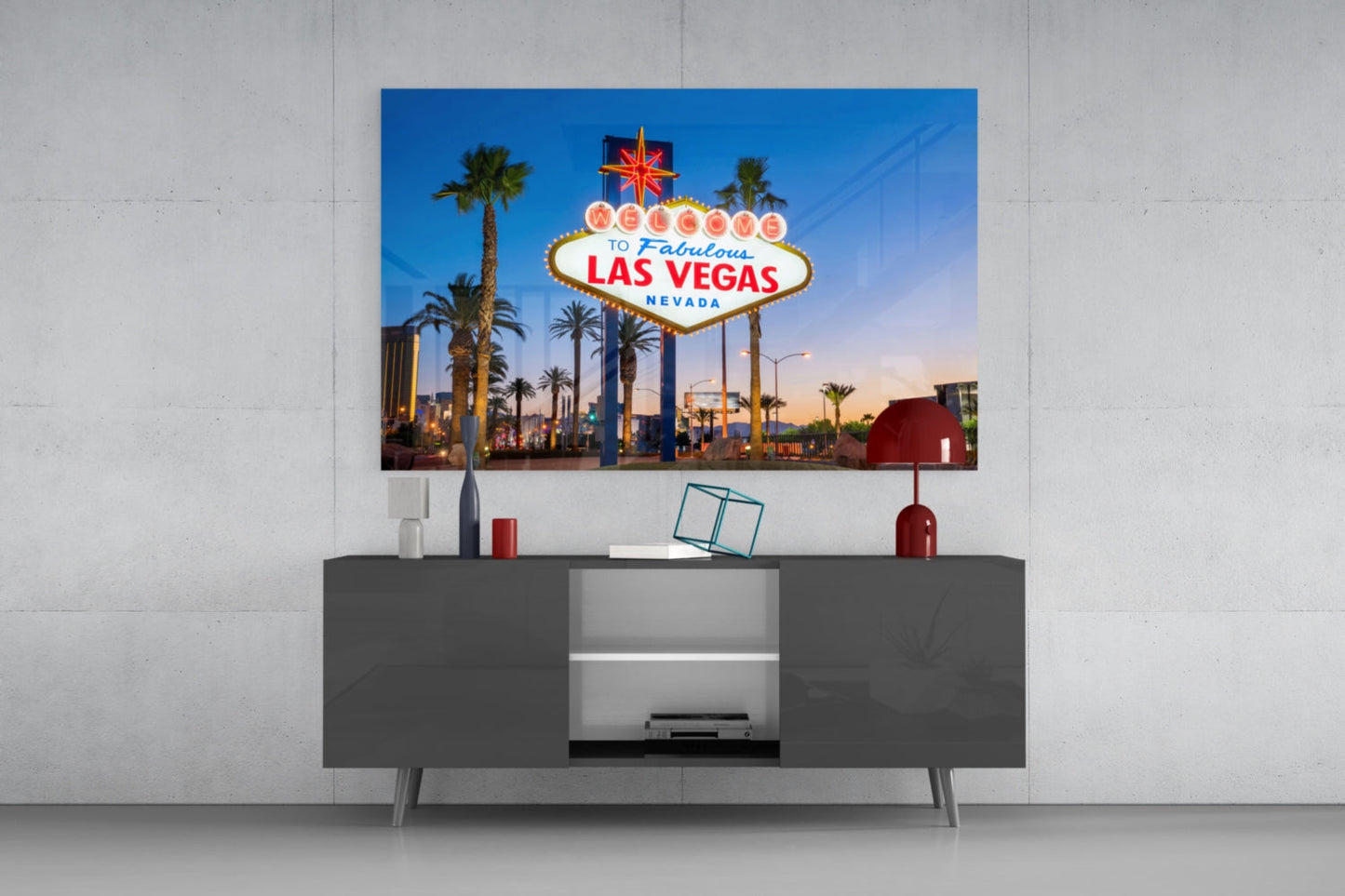 Vegas Glass Wall Art displaying the iconic "Welcome to Fabulous Las Vegas Nevada" sign mounted above a gray media console.