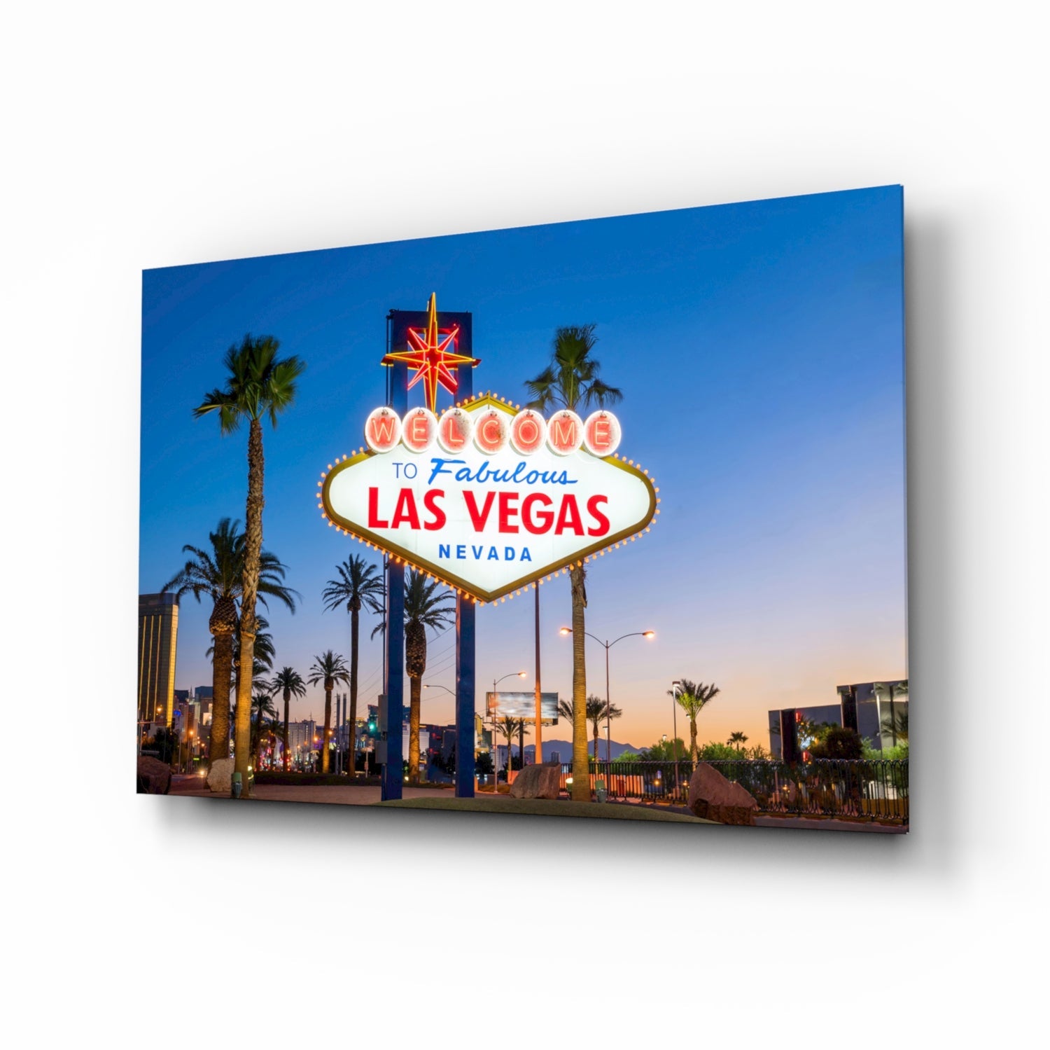 Glass wall art displaying the illuminated "Welcome to Fabulous Las Vegas Nevada" sign at dusk with palm trees and blue sky.