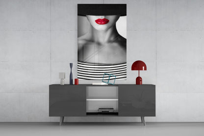Modern living room display featuring black and white portrait glass art with red lips above grey sideboard with red accents.
