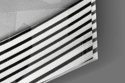 Close-up detail of layered black and white striped fabric or material with textured weave pattern.