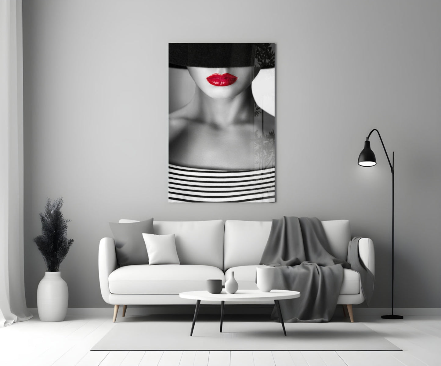 Red Lips Portrait glass wall art hanging above white sofa in minimalist monochrome living room interior.