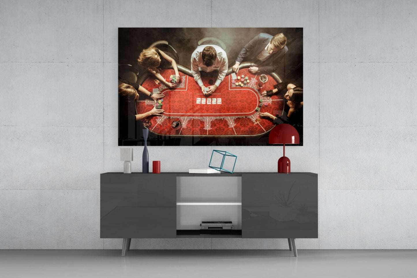 Overhead view of poker table with players and red felt displayed on wall-mounted television above gray media console.