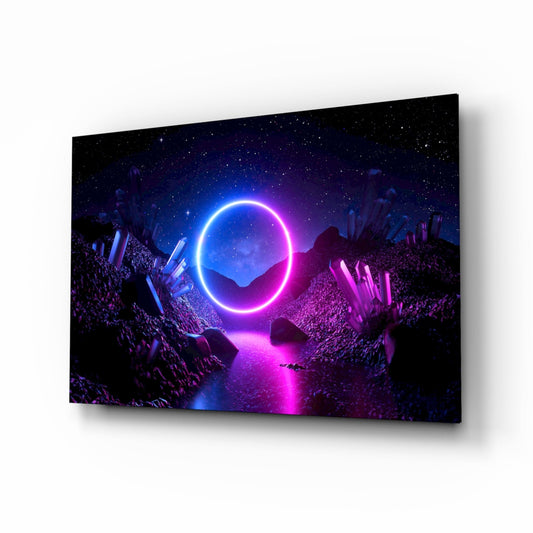 A glass wall art panel displayed at an angle showing a neon blue and magenta glowing circle framed by rocky terrain and crystalline formations against a starry night sky.