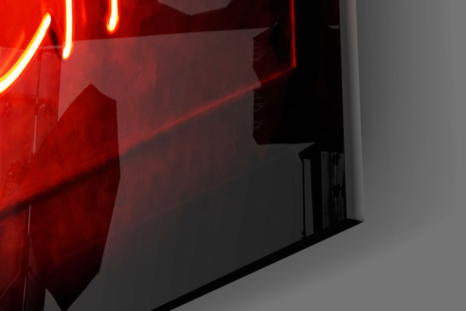 Red neon light casting glow on frosted glass wall art panel in modern interior space.