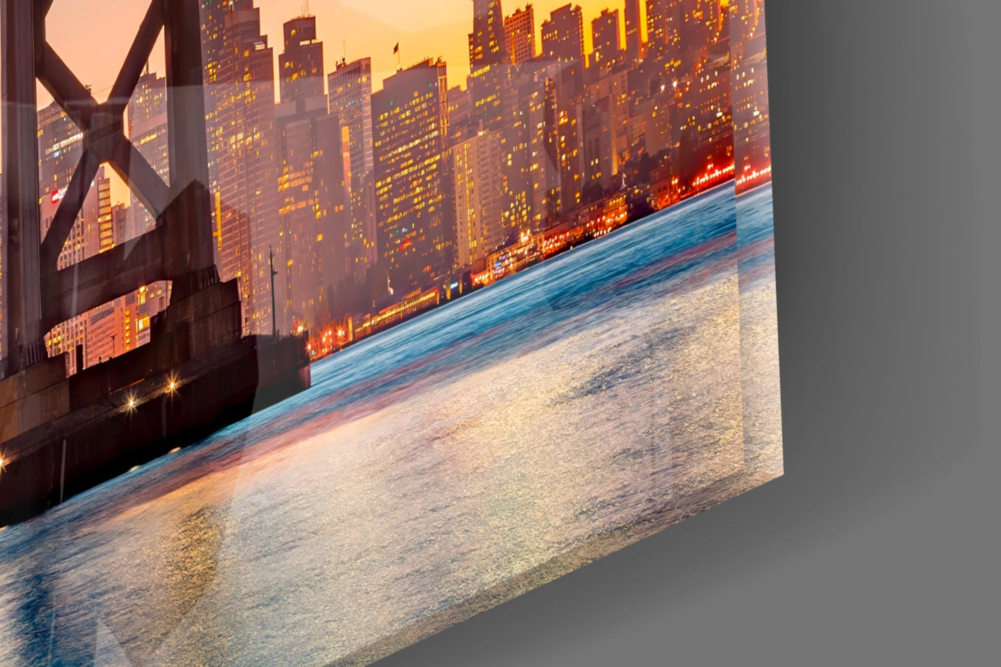 Glass wall art panel displaying sunset cityscape with illuminated skyscrapers and beach shore at perspective angle.