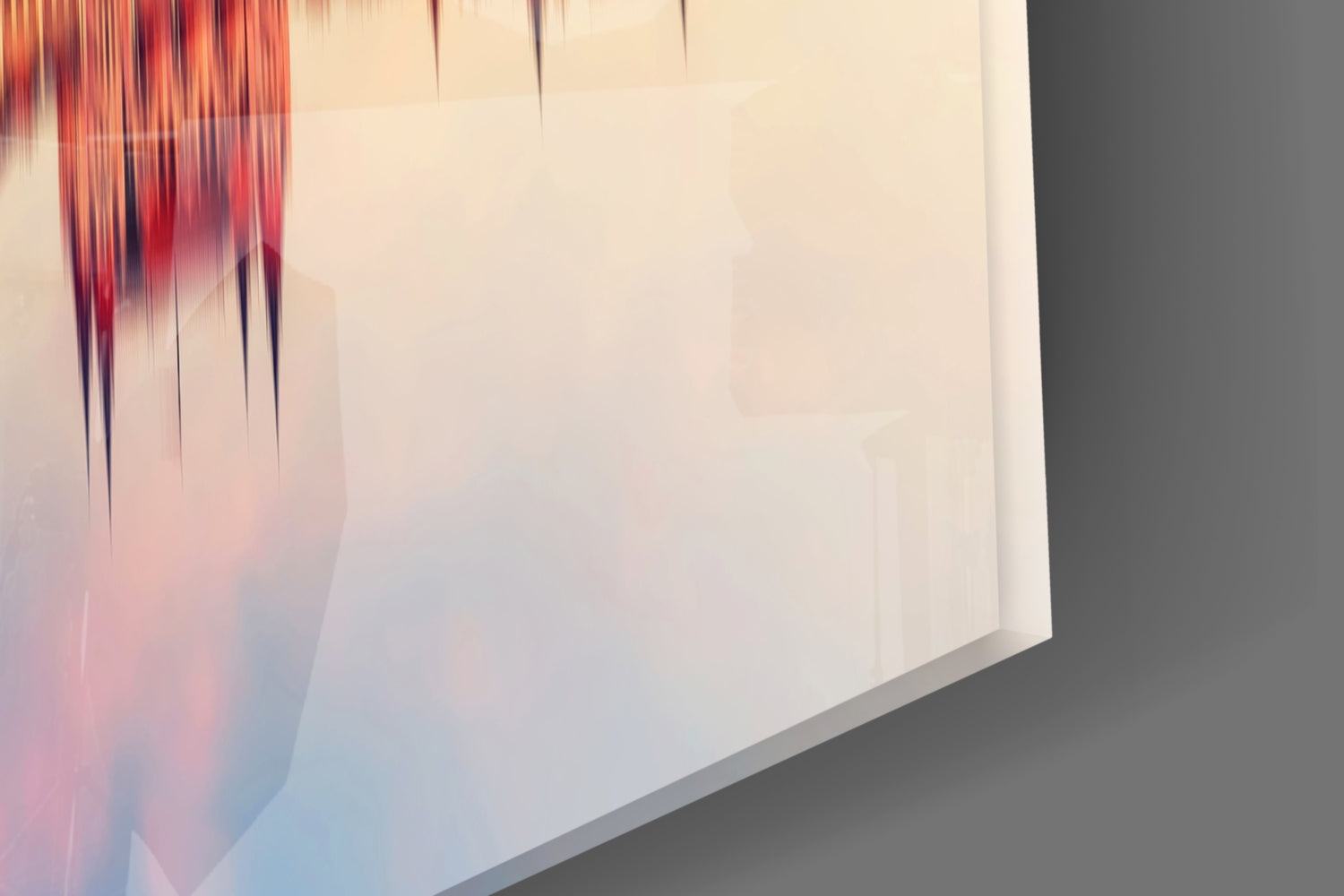 Close-up of glass wall art corner showing red, pink, and blue gradient streaks on cream background with gray edge detail.